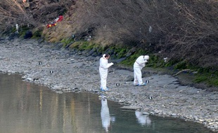 Des enquêteurs de la police autrichienne effectuent des prélèvements sur les berges de l'Inn où a été découvert le corps de Lucile, le 14 janvier 2014.