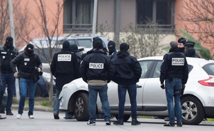Des policiers s'affairent à l'intérieur d'un périmètre de sécurité à Villejuif le 20 mars 2016 pour la reconstitution du meurtre d'Aurélie Châtelain.