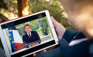 Une femme regarde sur un ordinateur l'allocution d'Emmanuel Macron, le 14 juin 2020.