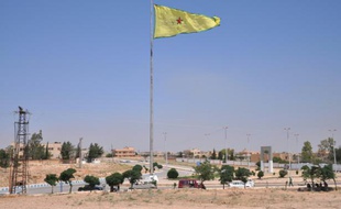 Un drapeau des YPG, milices du Parti de l'union démocratique (PYD, Kurdes de Syrie) flotte sur la ville de Tall Abyad, en Syrie, le 25 juin 2015