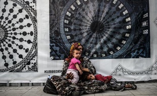 Une réfugiée syrienne mendie avec son enfant dans une rue d'Istanbul, le 16 juillet 2014