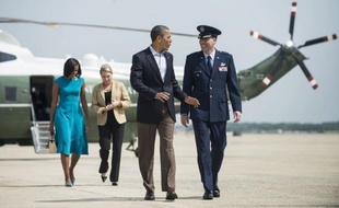 US President Barack Obama and US First Lady Michelle Obama (L rear) walk to Air Force One at Andrews Air Force Base May 5, 2012 Maryland. President Obama is traveling to Ohio and Virginia where he will hold rallies and officially begin his re-election bid for the 2012 US Presidential election. AFP PHOTO/Brendan SMIALOWSKI