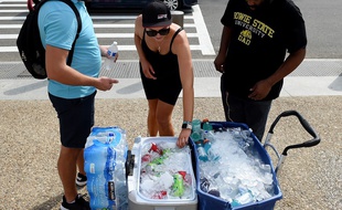 Des touristes achètent des bouteilles d'eau en pleine canicule à Washington, le