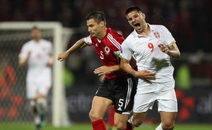 Albania's Lorik Cana (L) vies with Serbia's Aleksandar Mitrovic during the Euro 2016 qualifying football match between Albania and Serbia at the Elbasan Arena in Elbasan on October 8, 2015. AFP PHOTO / GENT SHKULLAKU