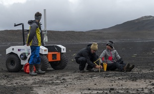 Sur cette photo prise le 19 juillet 2019, on voit des scientifiques travaillant à la NASA dans le champ de lave Lambahraun en Islande, où ils préparent leur nouvel explorateur spatial robotique pour la prochaine mission sur Mars.