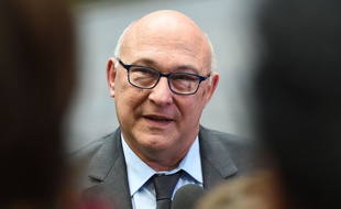 France's Finance Minister Michel Sapin arrives for a Eurogroup Finance ministers meeting in Brussels on November 6, 2014. Some 340 international companies have secured secret deals from Luxembourg, allowing many of them to slash their tax bills while maintaining a small presence in the small European duchy, leaked documents show. AFP PHOTO/Emmanuel Dunand