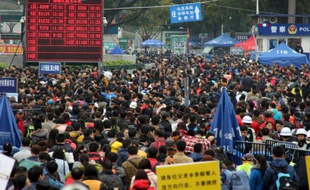 Des milliers de voyageurs, rentrant chez eux en province pour le Nouvel An chinois, attendent un train à l'une des gares principales de Canton, le 3 février 2016