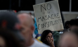 A woman holds a sign that reads 'No to the Constituent massacre' during a protest against the Government and the installation of the National Assembly in Caracas, Venezuela, 31 July 2017. The opposition keeps its protests agenda against Nicolas Maduro's Government the day after the National Constituent Assembly election. EFE/Miguel Gutierrez