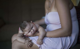 Gleyse Kelly da Silva holds her daughter Maria Giovanna as she sleeps in their house in Recife, Pernambuco state, Brazil, Wednesday, Jan. 27, 2016. Brazilian officials still say they believe there's a sharp increase in cases of microcephaly and strongly suspect the Zika virus, which first appeared in the country last year, is to blame. The concern is strong enough that the U.S. Centers for Disease Control and Prevention this month warned pregnant women to reconsider visits to areas where Zika is present. (AP Photo/Felipe Dana)/XFD109/690716147732/1601280208