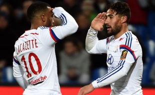 Lyon's French midfielder Nabil Fekir (R) and Lyon's French forward Alexandre Lacazette (L) react after scoring a goal during the French L1 football match between Montpellier and Lyon on March 8, 2015 at the La Mosson Stadium in Montpellier, southern France. AFP PHOTO / PASCAL GUYOT