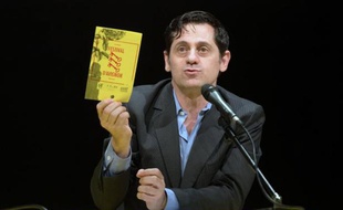 Le directeur du Festival d'Avignon, Olivier Py, montre le programme de l'édition 2014, le 20 mars 2014