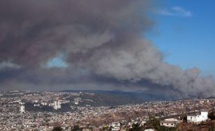 De la fumée se dégage d'un gigantestque feu de forêt au-dessus du port de Valparaiso au Chili, le 14 mars 2015.