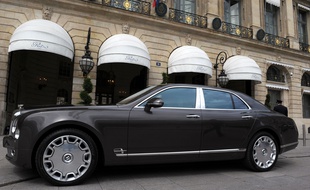 Une voiture de luxe devant une boutique de luxe à Paris. (Illustration)