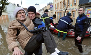 Une vieille dame est secourue par les pompiers à Cherbourg après les violentes inondations du 5 décembre 2010.