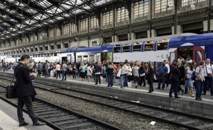 Des passagers attendent un train, dans la gare de Lyon à Paris le 16 juin 2014