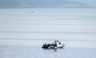 Des garde-côtes turcs interpellent des migrants qui essaient d'atteindre l'île grecque de Kos, en août 2015.