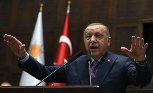 President of Turkey and leader of Justice and Development (AK) Party, Recep Tayyip Erdogan addresses his party's lawmakers at Grand National Assembly of Turkey (parliament) in Ankara on February 19, 2020. - Erdogan threatened on February 19, 2020 to launch an operation in Syria's Idlib region by the end of the month if Damascus fails to withdraw behind Turkish military positions. (Photo by Adem ALTAN / AFP)