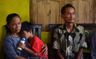 Les parents de Sumarti Ningsih, jeune femme indonésienne victime d'un meurtre à Hong Kong, dans leur maison à Cilacap, sur l'île de Java en Indonésie, le 4 novembre 2014