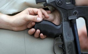 Une femme militaire tient un "Famas"