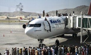 Des citoyens sur le tarmac de l'aéroport de Kaboul en Afghanistan, le 16 août 2021.