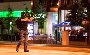 Un policier à Munich près du centre commercial où a eu lieu la tuerie qui a fait au moins 10 morts le 22 juillet 2016.