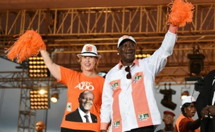 Le président sortant de la Côte d'Ivoire Alassane Ouattara (G) aux côtés de son épouse Dominique Ouattara, le 23 octobre 2015 à Abidjan