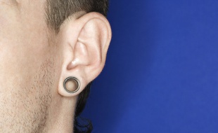 Illustration: Un homme arbore un écarteur à l'oreille.