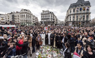 Foule rassemblée pour une minute de silence en hommage aux victimes des attentats, place de la Bourse à Bruxelles, le 22 mars 2017.