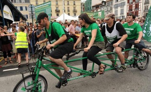 Des gens pédalent sur un vélo à quatre places lors du départ d'un tour de l'Hexagone de 5.600 km pour lutter contre le réchauffement climatique, lancé par le mouvement écologiste Alternatiba, le 5 juin 2015