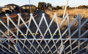 Une barrière bloque la route d'une zone interdite à Namie, dans la préfecture de Fukushima, le 21 février 2014.