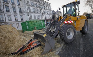 Des employés de la ville de Paris nettoient le fumier déposé par les manifestants devant le ministère de l'Agriculture, le 16 janvier 2013.