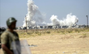 Photo d'affrontements dans la ville syrienne de Kobané prise le 27 juin 2015 depuis la localité turque de Suruç