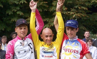 Le coureur italien Marco Pantani, vainqueur du Tour de France 1998, sur le podium avec l'Allemand Jan Ullrich et l'Américain Bobby Julich.