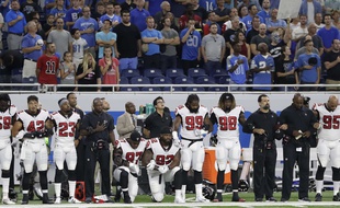 Grady Jarrett et Dontari Poe de l'équipe des Falcons d'Atlanta, un genou à terre durant l'hymne américain.