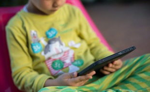 Illustration d'un enfant avec une tablette.