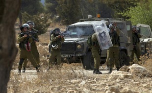 Des forces de sécurité israéliennes tirent des gaz lacrymogènes sur des manifestants palestiniens, le 2 octobre 2015 à Budrus, à l'ouest de Ramallah, en Cisjordanie
