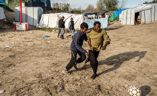 Des migrants jouent au foot à Calais le 29 octobre 2015.