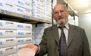 FRANCE, La Seyne-sur-Mer : (FILES) A file picture taken on January 17, 2001 in La Seyne-sur-Mer, southern France, shows the President of Poly Implant Prothese (PIP) breast implants company, Jean-Claude Mas, holding an implant. Between 400,000 and 500,000 women around the world are believed to have received PIP implants, the now-defunct company that Mas founded in southern France. At the end of October 2012, 14.300 women in France had their PIP breast implants removed (10.042 as a precaution and 3.290 following a rupture), after French justice decided to support financially the surgery operations and the medical tests. The first trial with almost 5.000 plaintiffs and some 200 lawyers, will start in the Spring of 2013 in Marseille, southern France.