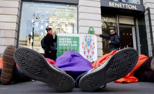 Des militants sont couchés sur le sol devant un magasin Benetton, près de la plce de l'Opéra, à Paris, le 9 décembre 2014, pour demander réparation après le drame du Rana Plaza