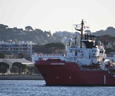 TOPSHOT - The Ocean viking " rescue ship of European maritime-humanitarian organisation "SOS Mediterranee" escorted by a military boat arrives at Toulon, southern France, with migrants on board, on November 11, 2022. - France warned Italy of "severe consequences" as it was set to take in on November 11, 2022 a charity ship carrying more than 200 migrants rescued in the Mediterranean, who were denied entry by Rome. (Photo by CHRISTOPHE SIMON / AFP)