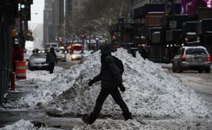 Un piéton passe devant un tas de neige dans une rue de Times Square, après une tempête de neige à New York, le 27 janvier 2015