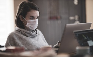 Une salariée qui travaille avec un masque.