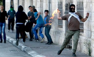 Un Palestinien lance un cocktail Molotov vers les forces de l'ordre israéliennes, à l'entrée de Bethlehem, le 11 novembre 2014