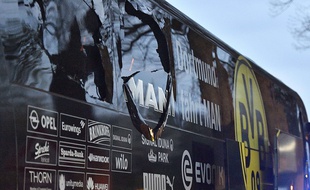 A window of Dortmund's team bus is damaged after an explosion before the Champions League quarterfinal soccer match between Borussia Dortmund and AS Monaco in Dortmund, western Germany, Tuesday, April 11, 2017.