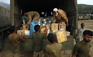 Des soldats pakistanais distribuent de l'aide aux rescapés des inondations, le 16 août 2010.