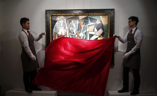 Staff members from Christie's auction house unveil the painting "Les Femmes d'Alger (Version "O")" by painter Pablo Picasso during a media preview in Hong Kong Wednesday, April 1, 2015. The painting is expected to fetch US$140 million at the Christie's New York evening sale on May 11. (AP Photo/Kin Cheung)/XKC102/150064001990/1504011152
