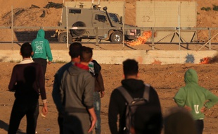 Des Palestiniens font face à des soldats israéliens à la frontière entre Gaza et Israël, le vendredi 20 décembre.