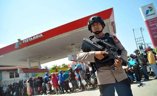 Un officier de police devant une station service dans la ville de Palu en Indonésie, le 1er octobre 2018.