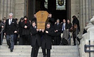 Des employés des pompes funèbres portent le cercueil de Bernard Mazières, ancien journaliste politique du Parisien assassiné fin décembre, à l'issue de la cérémonie des obsèques, le 14 janvier 2011, en l'église Saint-Sulpice à Paris.