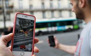 Un joueur regarde l'application Pokemon Go sur son smartphone dans les rues de Paris, le 26 juillet 2016